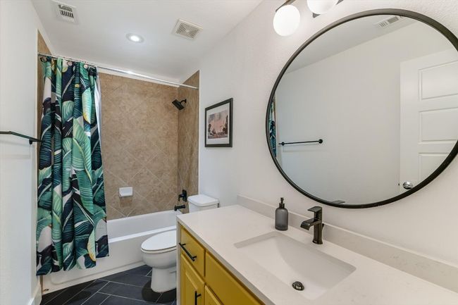 Bathroom featuring tile patterned floors, vanity, shower / bath combo with shower curtain, toilet, and recessed lighting | Image 20