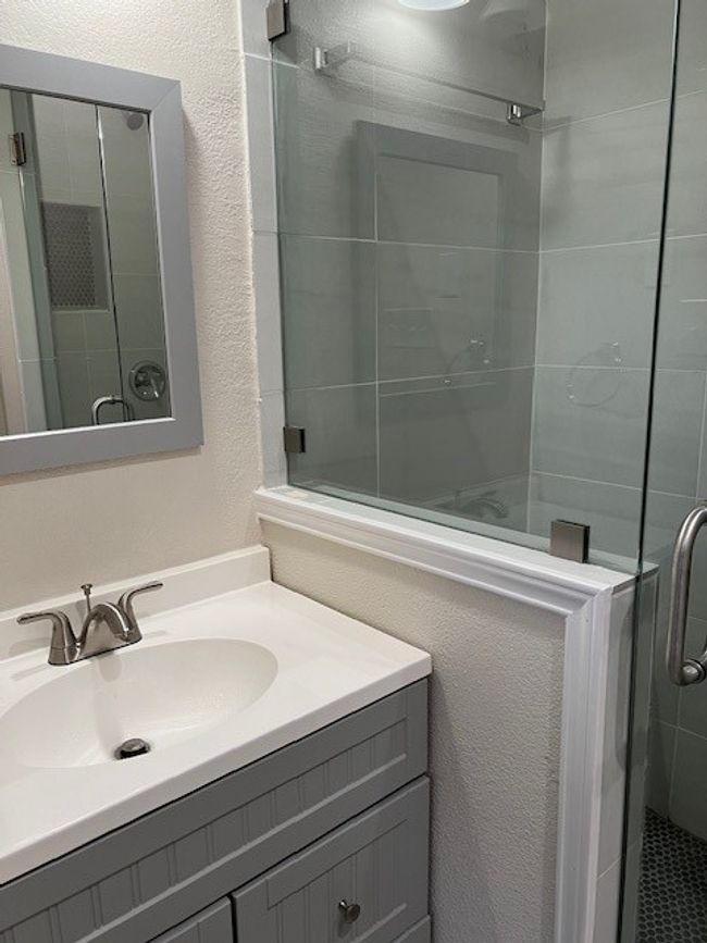 Full bathroom featuring vanity, a stall shower, and a textured wall | Image 7