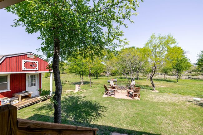 View of yard with an outbuilding and an outdoor fire pit | Image 25