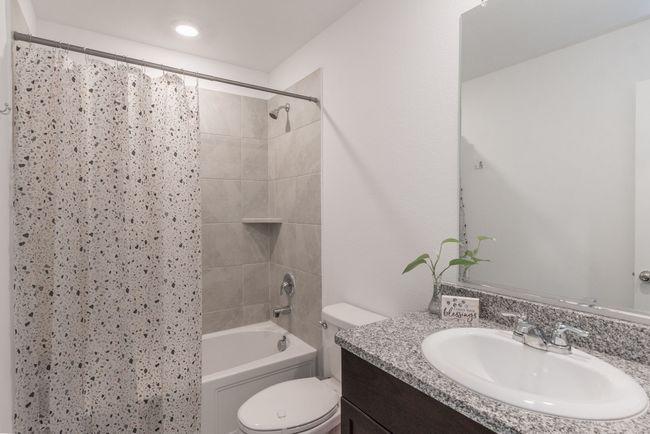 Full bath featuring shower / bath combo, toilet, and vanity | Image 12