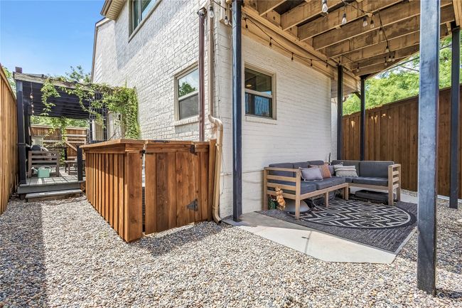 Fenced backyard with a wooden deck | Image 36