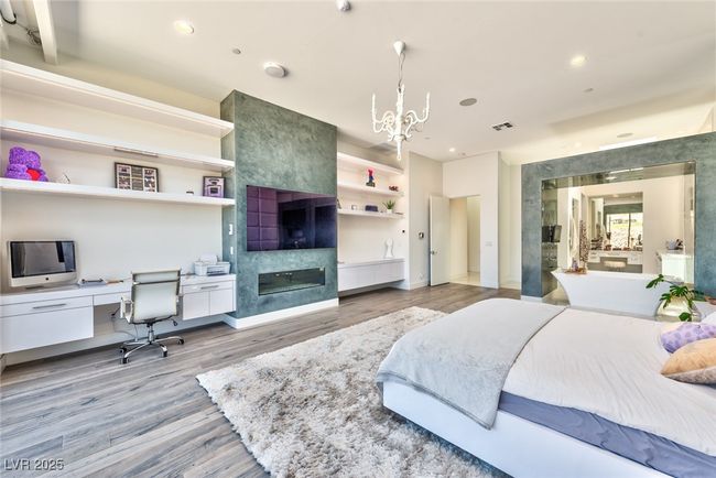 Bedroom featuring recessed lighting, wood finished floors, and an inviting chandelier | Image 17