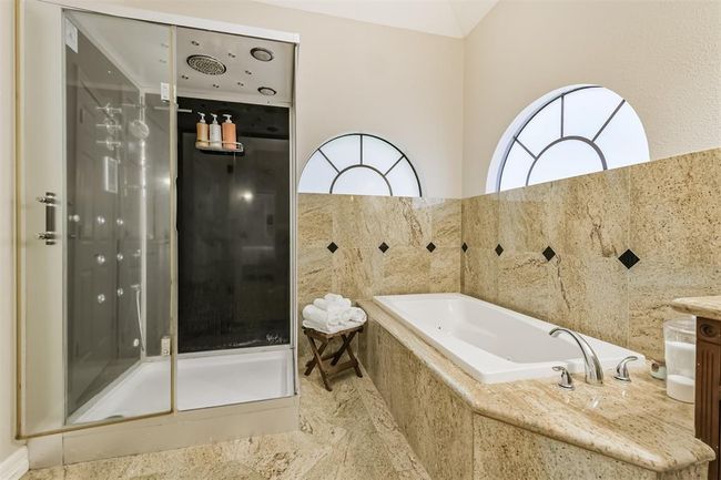 Indulge in ultimate relaxation with a luxurious steam shower in the primary bathroom. | Image 26