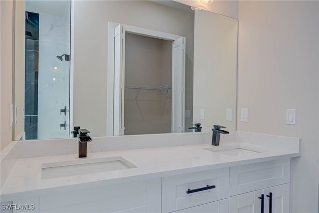 Bathroom featuring double vanity, a sink, and a spacious closet | Image 13