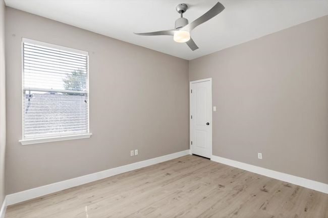 Spare room featuring light wood-style flooring and a ceiling fan | Image 17