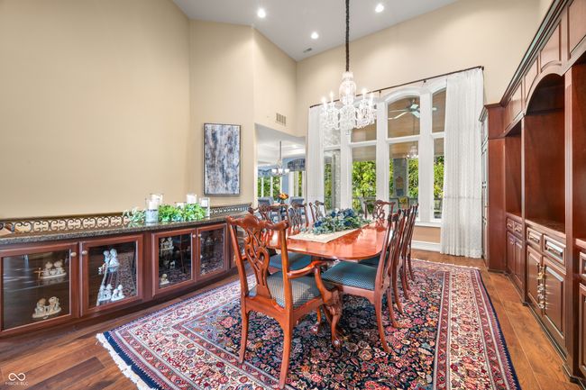 dining space with visible vents, wood finished floors, recessed lighting, and a towering ceiling | Image 13