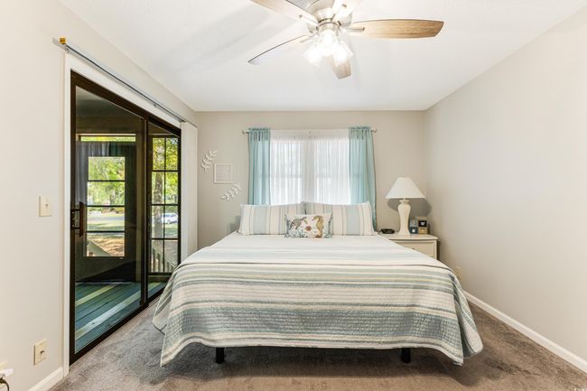 Bedroom with carpet flooring, access to outside, baseboards, and ceiling fan | Image 11