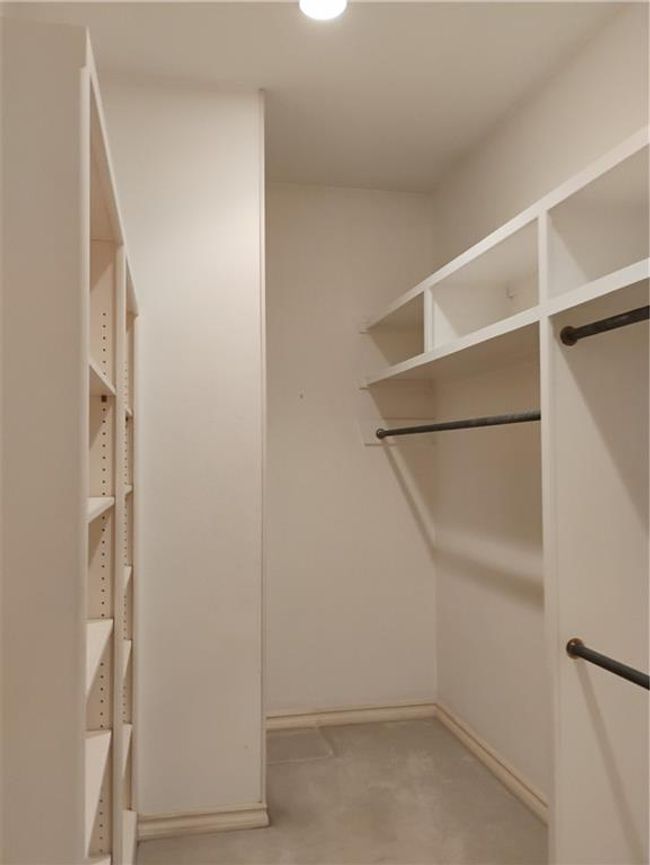 Primary bedroom walk in closet #1 with carpet flooring | Image 53