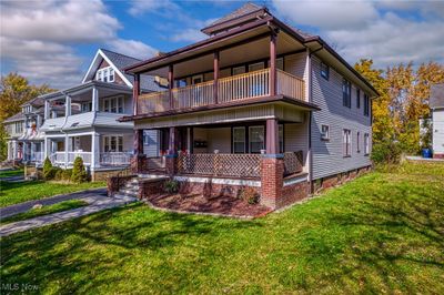 View of front of property with covered porch, a balcony, and a front yard | Image 3