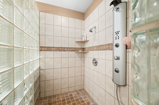 bathroom featuring a tile shower | Image 95