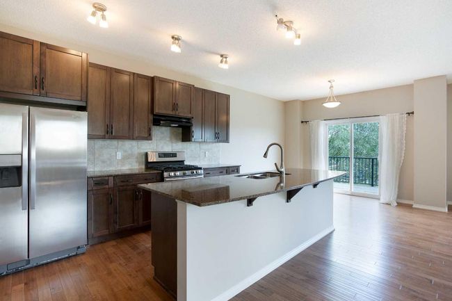 32 Drake Landing Hill, House other with 3 bedrooms, 3 bathrooms and 4 parking in Okotoks AB | Image 4