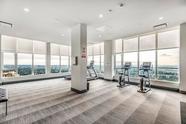 Workout area with light colored carpet, healthy amount of natural light, and recessed lighting | Image 22