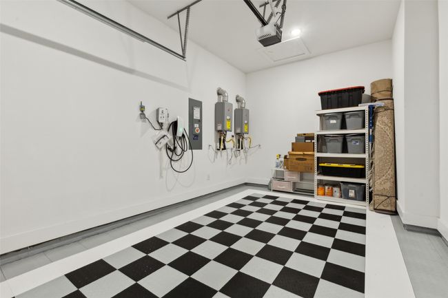 Garage with a garage door opener and baseboards | Image 35