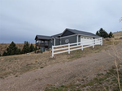 View of front of home with a rural view and a garage | Image 2