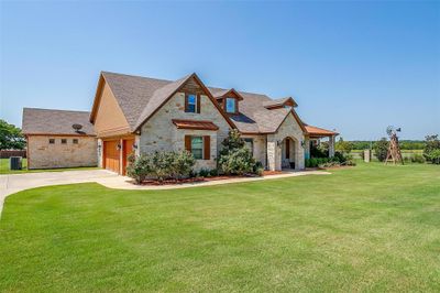 View of front facade with a front lawn, a playground, cooling unit, and a garage | Image 3