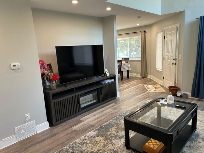 Living room with wood finished floors, recessed lighting, and baseboards | Image 25