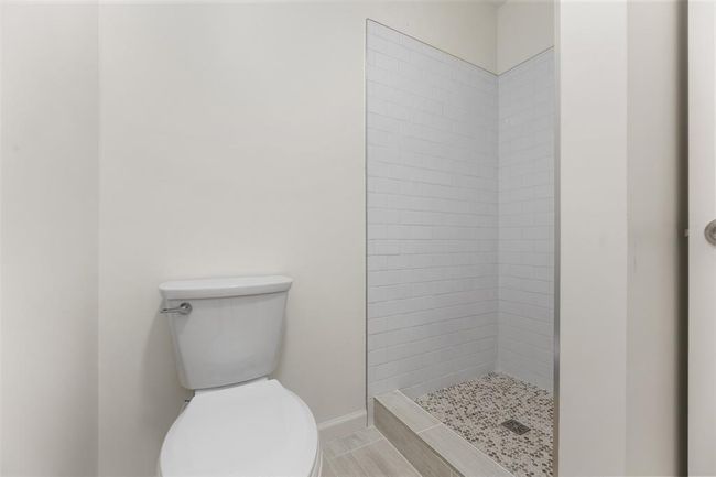 Full bathroom with contemporary updates and tiled accents. | Image 18