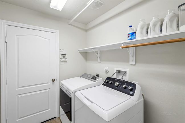 Spacious laundry room with shelf. | Image 19