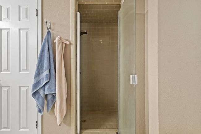 Full bath with a stall shower and a textured wall | Image 17