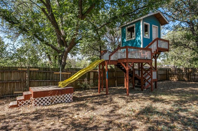 View of jungle gym featuring a fenced backyard | Image 25