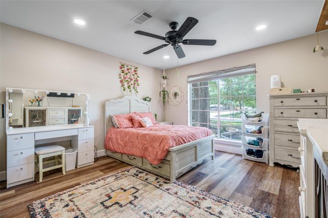 This spacious bedroom boasts a ceiling fan for comfort, a large window with privacy blinds, vinyl plank flooring, and en-suite bathroom, creating the perfect retreat.Ask ChatGPT | Image 11