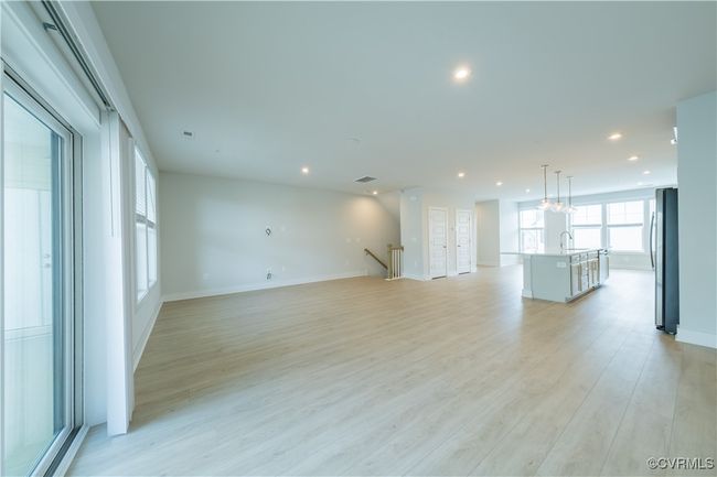Unfurnished living room with recessed lighting, light wood-style flooring, a sink, and baseboards | Image 10