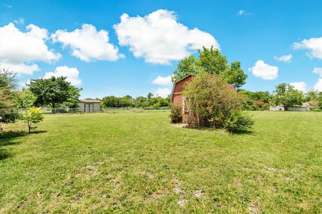 View of extra back lot area behind fenced yard | Image 28