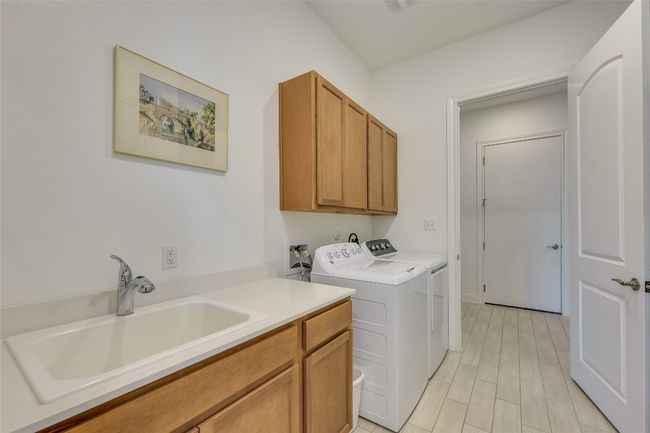 Washroom with separate washer and dryer, cabinet space, and wood finish floors | Image 19