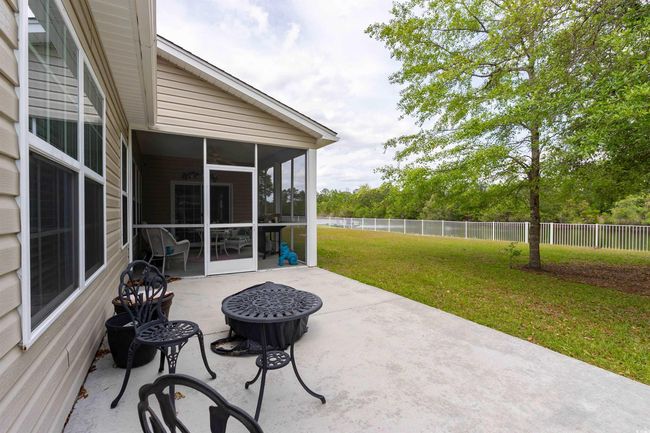 View of patio / terrace featuring a fenced backyard and a sunroom | Image 26