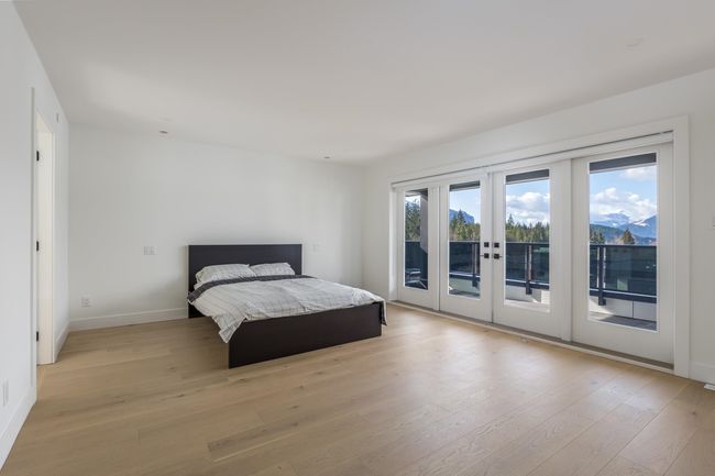 Bedroom with access to exterior, light wood-style floors, baseboards, and french doors | Image 19