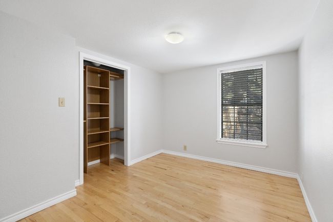Unfurnished bedroom featuring a spacious closet, light wood-style flooring, and baseboards | Image 15