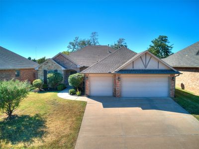 View of front facade featuring a front yard and a garage | Image 1