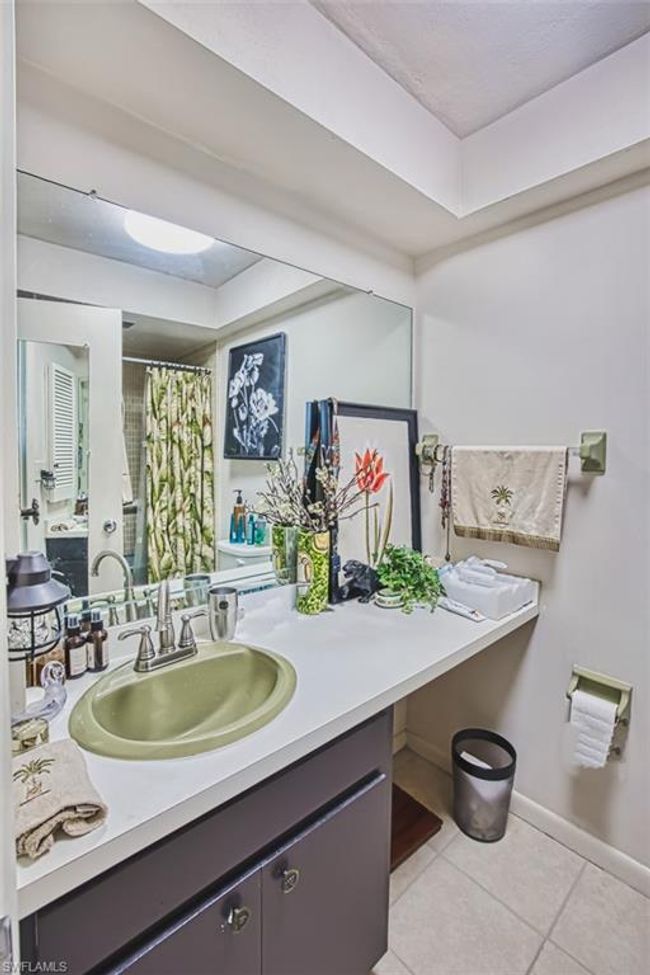 Bathroom with tile patterned floors, vanity, a raised ceiling, and curtained shower | Image 25