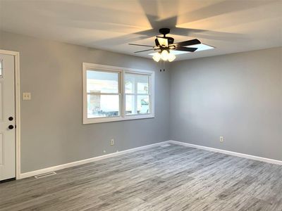 Unfurnished room featuring hardwood / wood-style floors and ceiling fan | Image 2