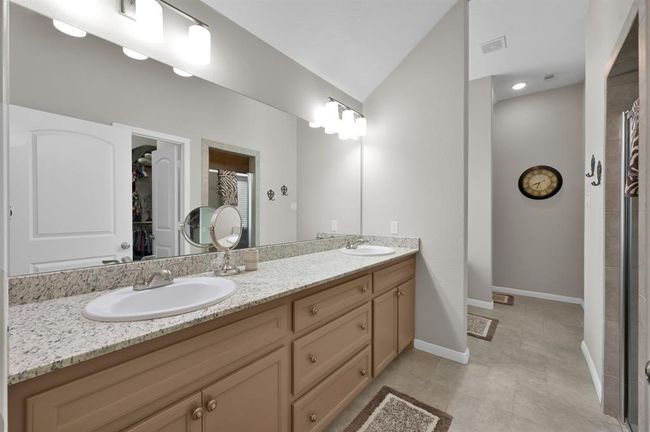 Custom cabintery with double sinks & granite countertops | Image 22