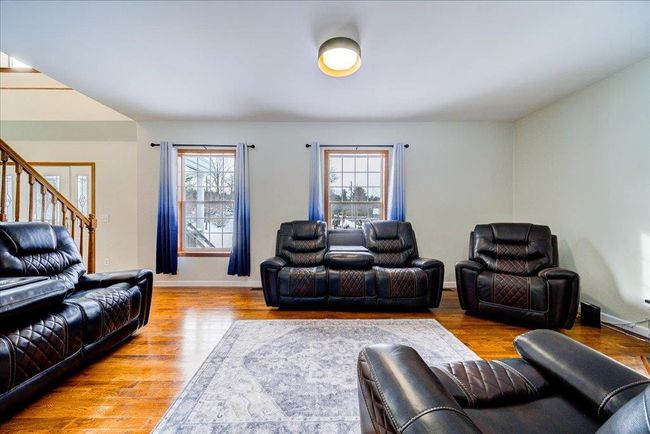 Living area with wood finished floors, stairs | Image 18