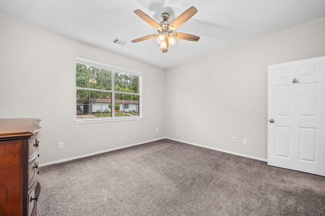 Unfurnished room with ceiling fan, baseboards, carpet floors, and visible vents | Image 22