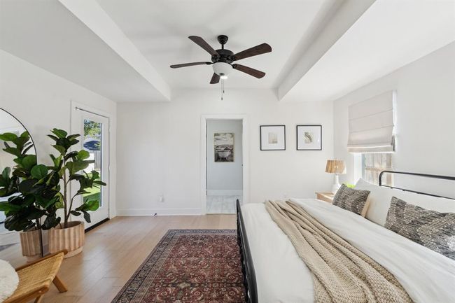 Another view of the primary suite highlights the doorway leading to the private ensuite bathroom. | Image 16
