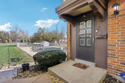 Doorway to property featuring a yard | Image 2