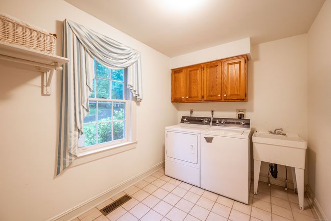 Huge Laundry Room with slop sink and cabinetry | Image 16