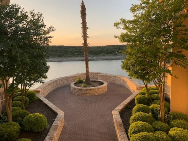 Patio terrace at dusk with a water view and a patio | Image 29