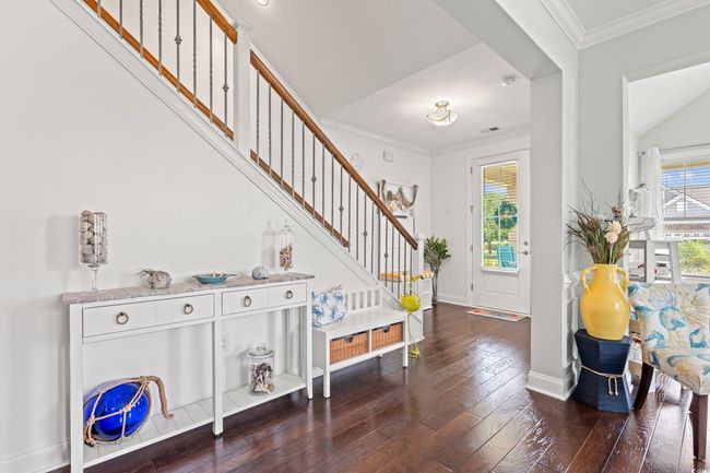 Entryway with stairs, wood-type flooring, plenty of natural light, and crown molding | Image 6