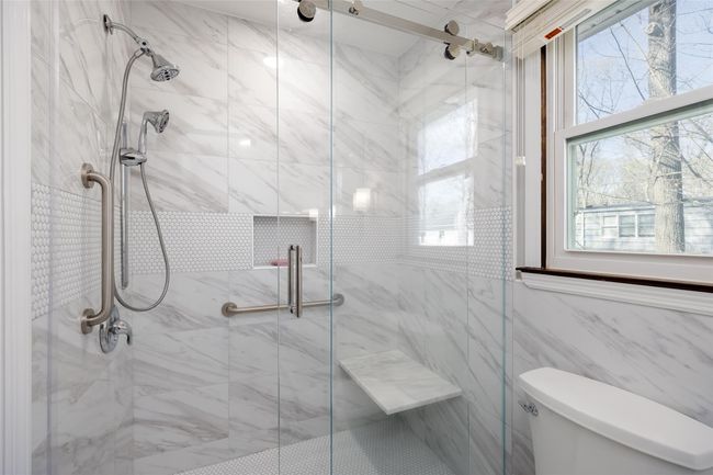 Full bathroom featuring toilet and a stall shower | Image 31