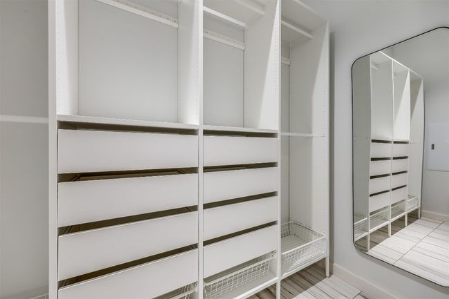 The closet is thoughtfully designed with custom shelving and drawers, providing ample storage space that keeps everything organized and easy to access | Image 26