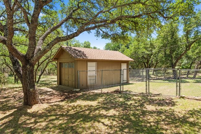 View of outbuilding with a gate, fence, and an outbuilding | Image 39