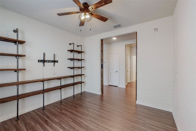 Empty room featuring wood finished floors, baseboards, and ceiling fan | Image 12