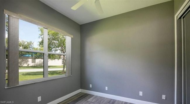 Empty room featuring hardwood / wood-style flooring and ceiling fan | Image 7