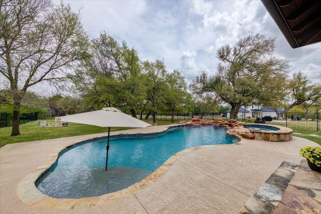 View of pool, hot tub, and patio area | Image 36