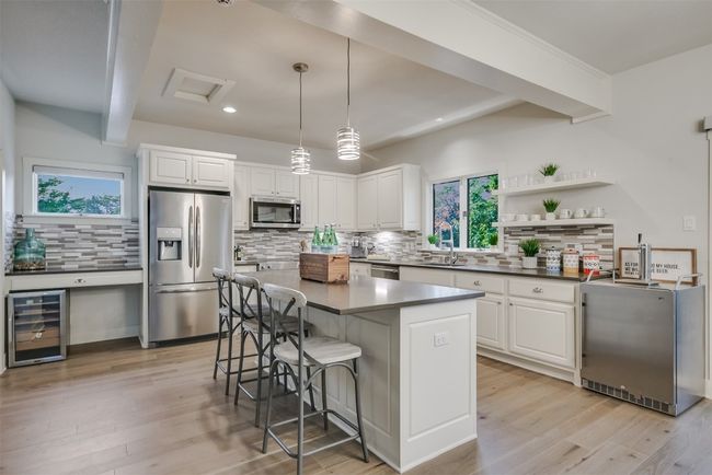 The gourmet kitchen boasts sleek quartz countertops that provide a luxurious surface for meal preparation | Image 10