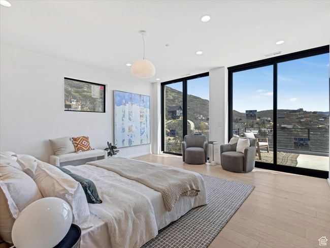 Bedroom featuring expansive windows, visible vents, recessed lighting, access to exterior, and wood finished floors | Image 20